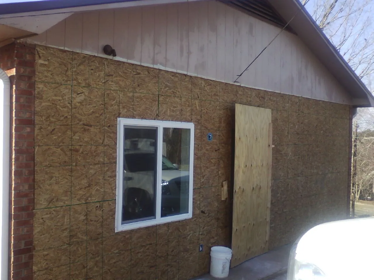 OSB sheathing on a garage addition wall before siding in Overbrook