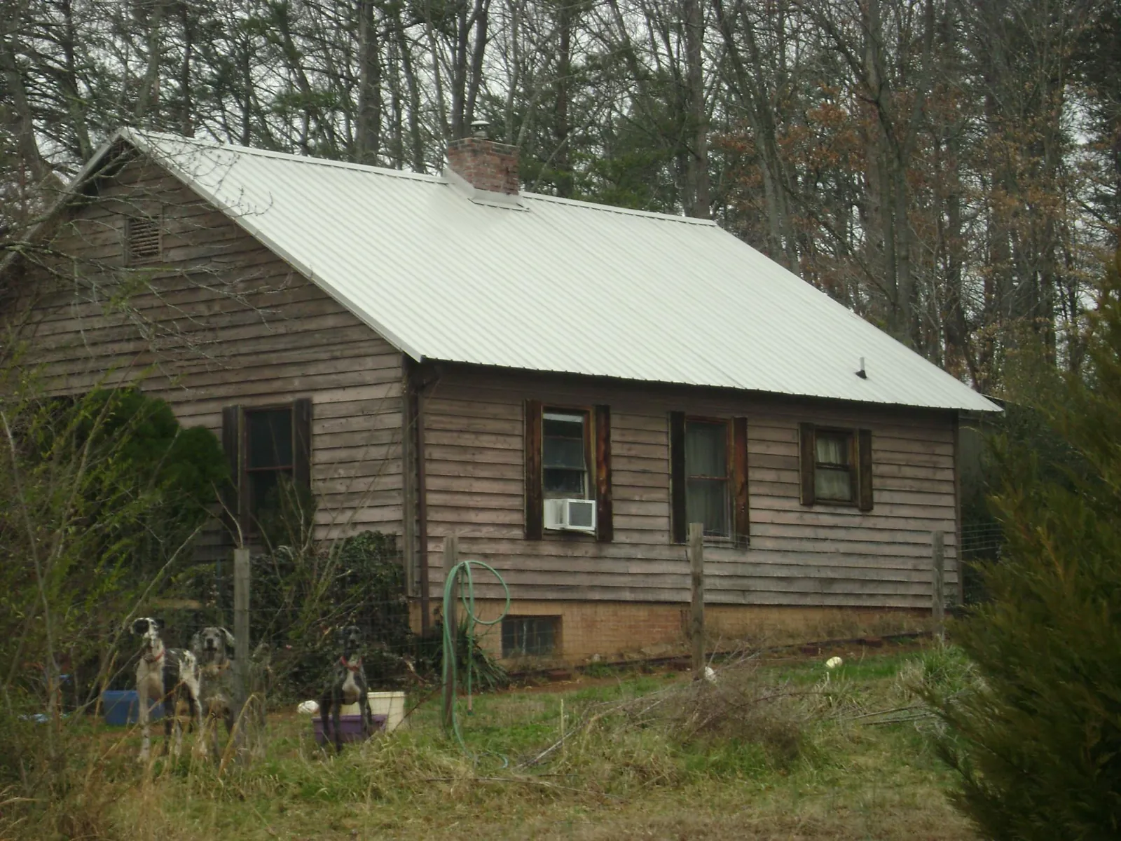 White metal roof on an old wood sided farmhouse, from a Metal Roof Installation job in Overbrook